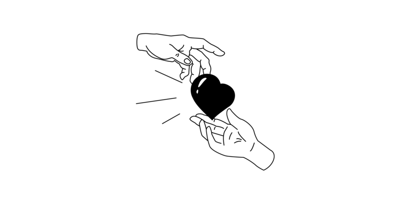 Eine Hand übergibt einer anderen Hand ein Herz.